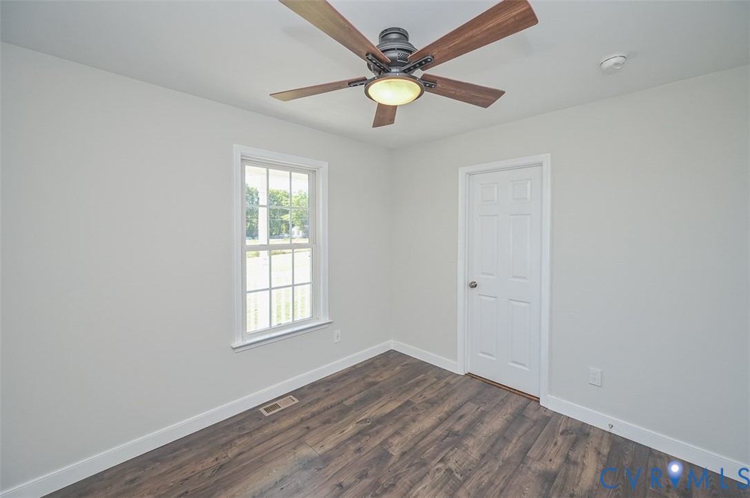 8441 Buffin Road Henrico, VA 23231 - Photo 32 of 50 an empty room with wooden floor ceiling fan and windows