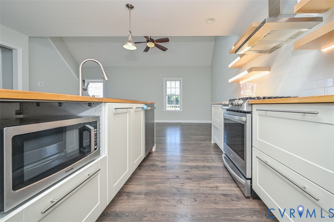 8441 Buffin Road Henrico, VA 23231 - Photo 8 of 50 a kitchen with a stove and a microwave