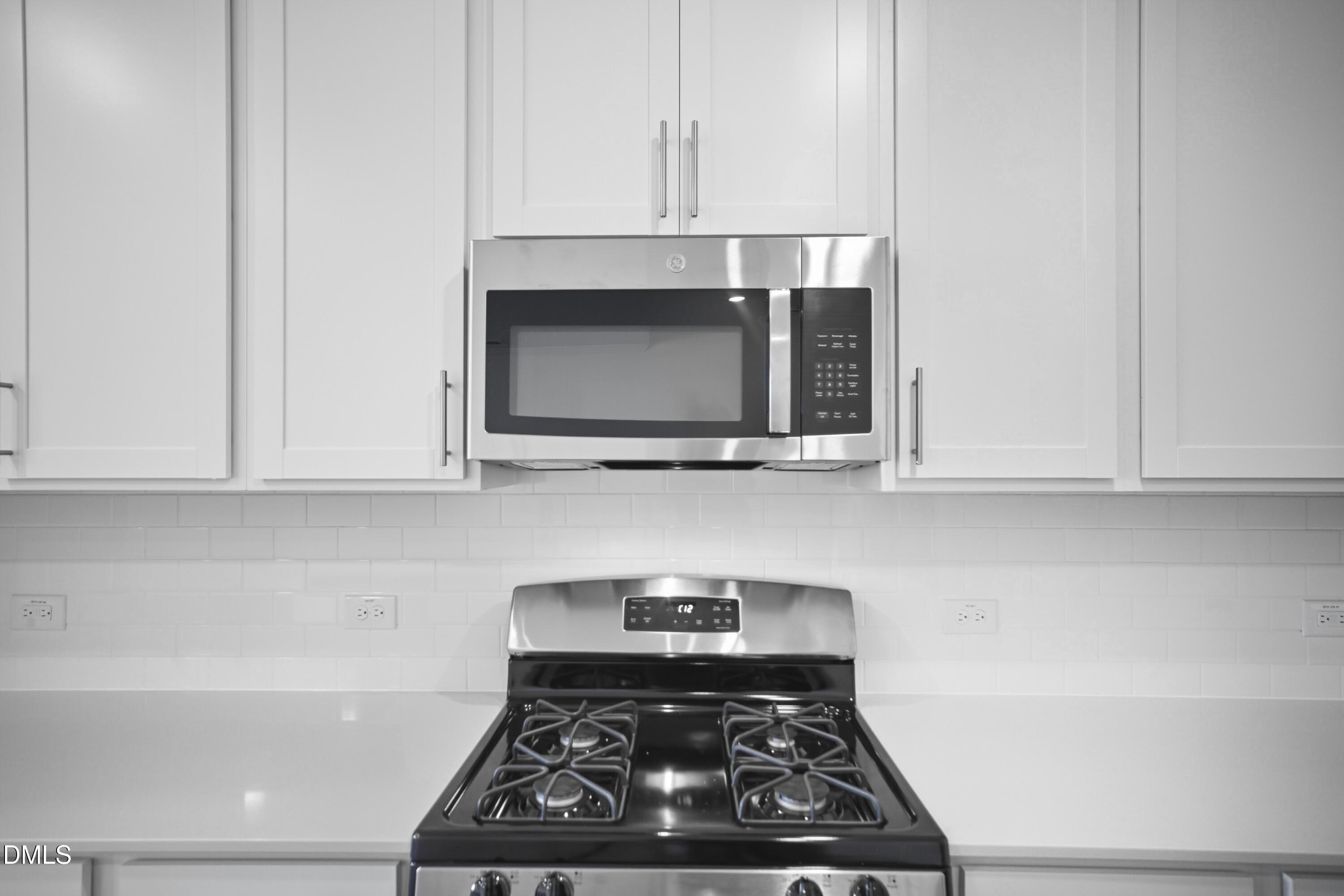 2921 Hickory Fld Drive Raleigh, NC 27616 - Photo 12 of 30 a kitchen with stainless steel appliances granite countertop white cabinets and a stove top oven