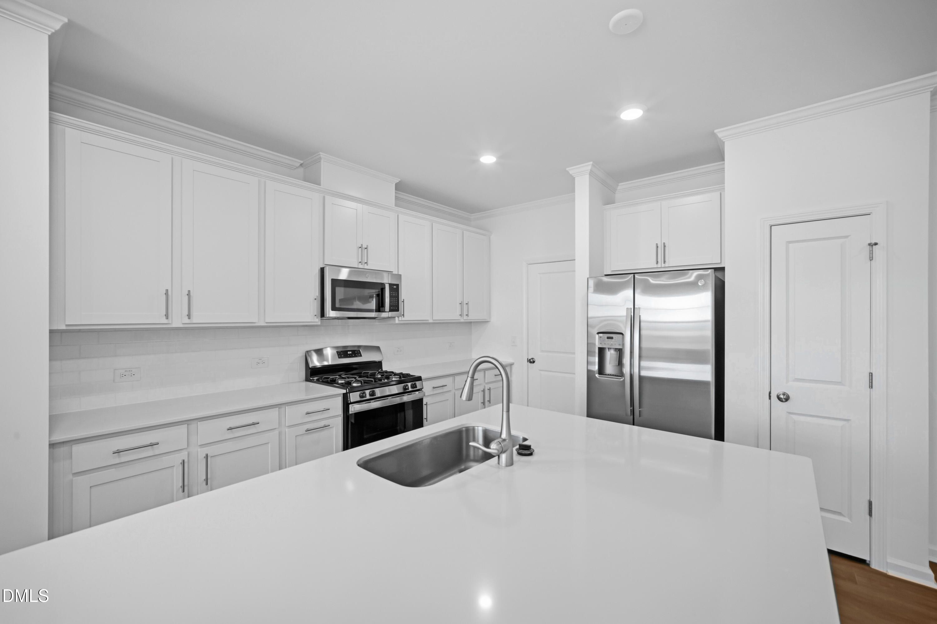 2921 Hickory Fld Drive Raleigh, NC 27616 - Photo 9 of 30 a kitchen with granite countertop a refrigerator stove top oven and sink