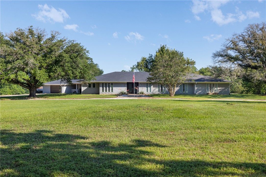 871 Cazey Loop Franklin, TX 77856 - Photo 35 of 42 a front view of a house with a garden
