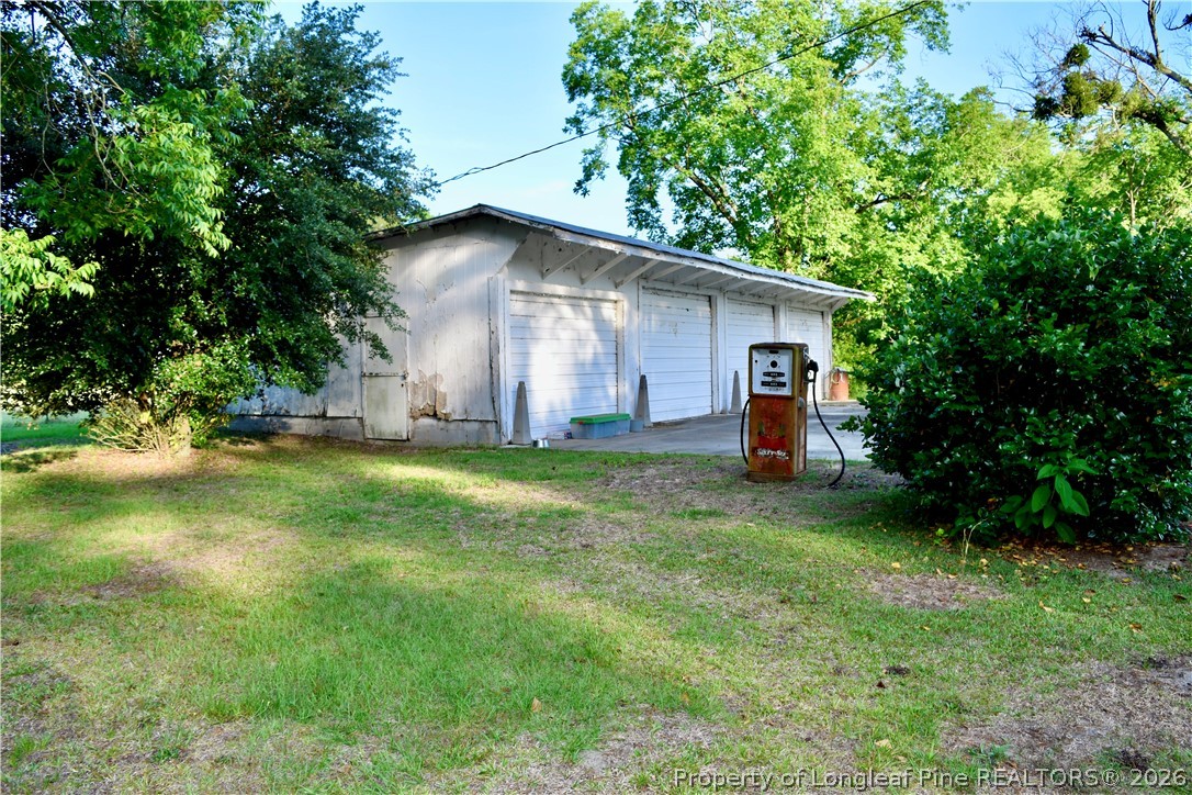 5309 Tobacco Road Orrum, NC 28369 - Photo 39 of 44 a backyard of a house with plants and large tree