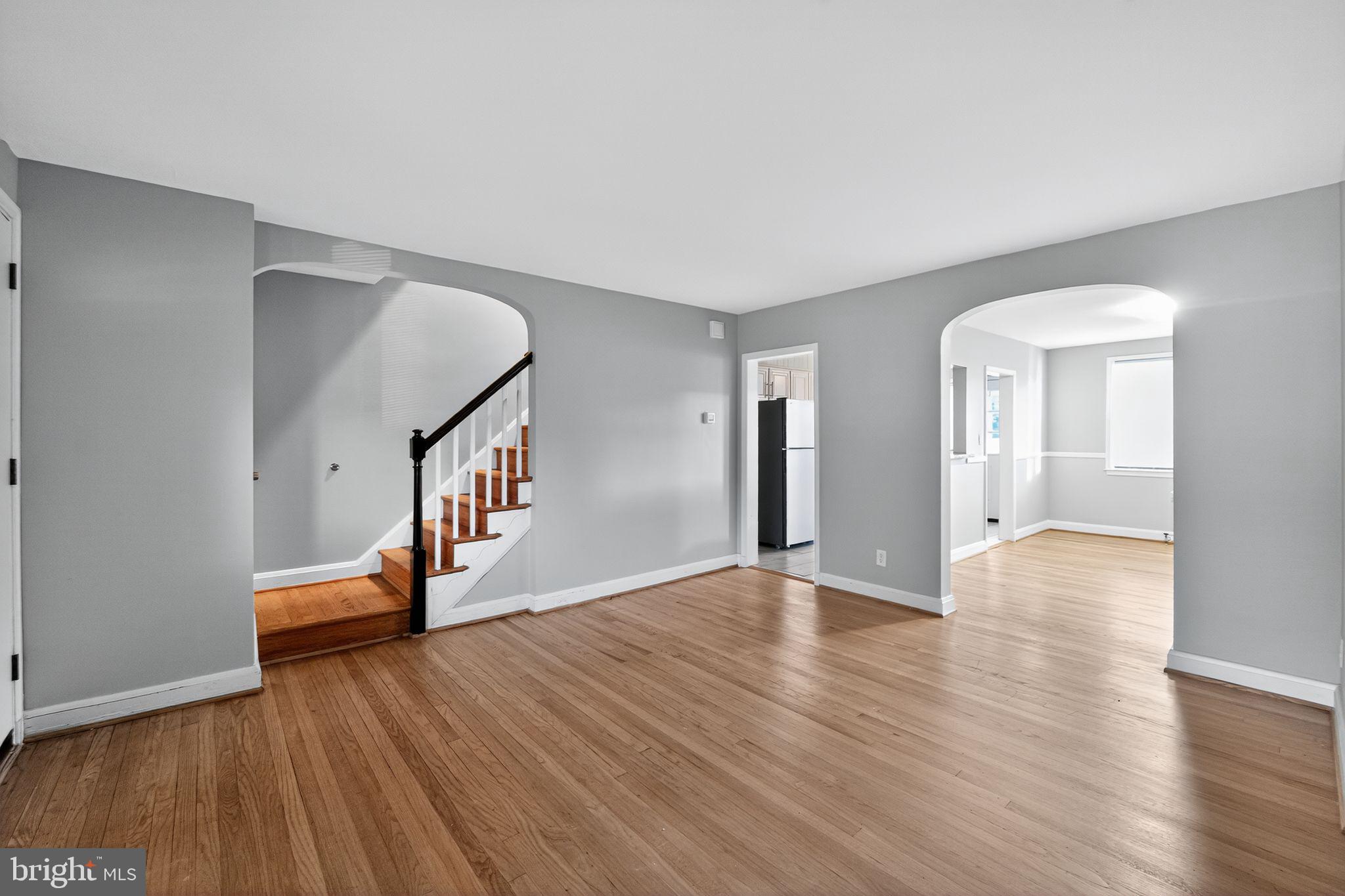 1017 Wicklow Road Baltimore, MD 21229 - Photo 15 of 34 a view of an empty room with wooden floor and a window