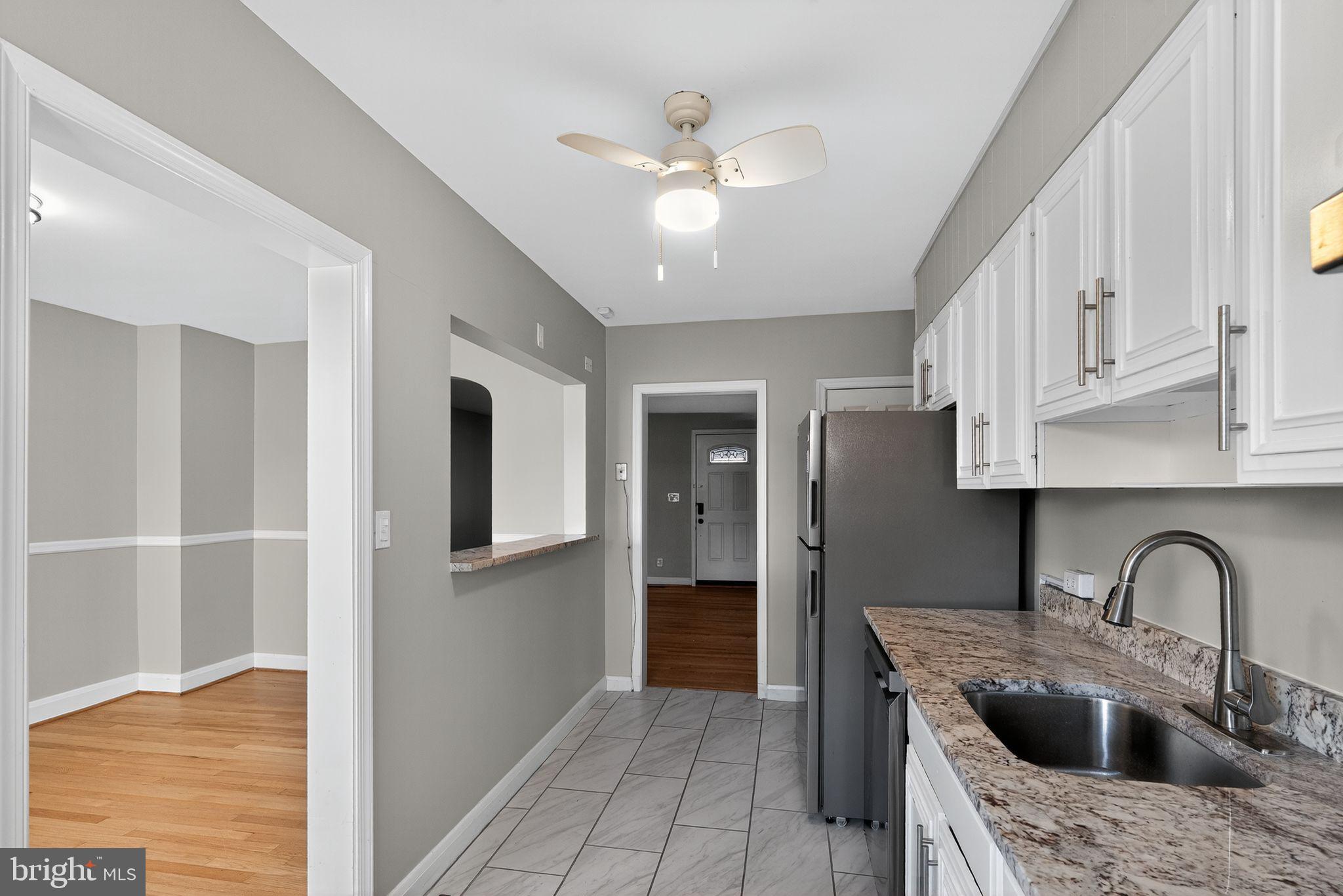 1017 Wicklow Road Baltimore, MD 21229 - Photo 16 of 34 a kitchen with stainless steel appliances granite countertop a sink a refrigerator and cabinets