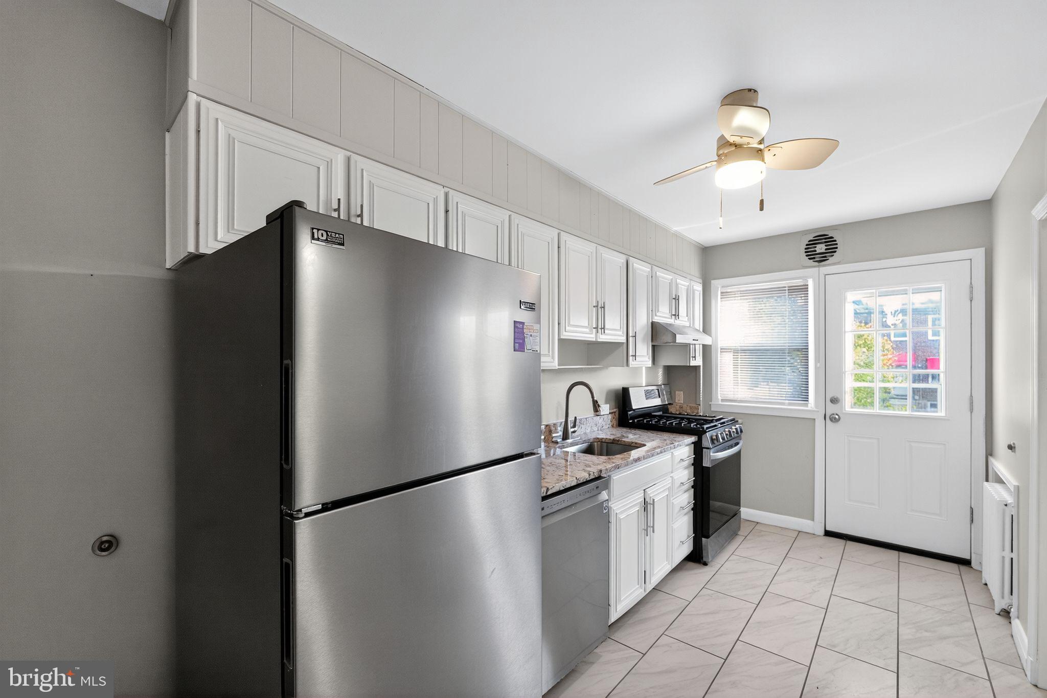 1017 Wicklow Road Baltimore, MD 21229 - Photo 17 of 34 a kitchen with stainless steel appliances a refrigerator sink and stove