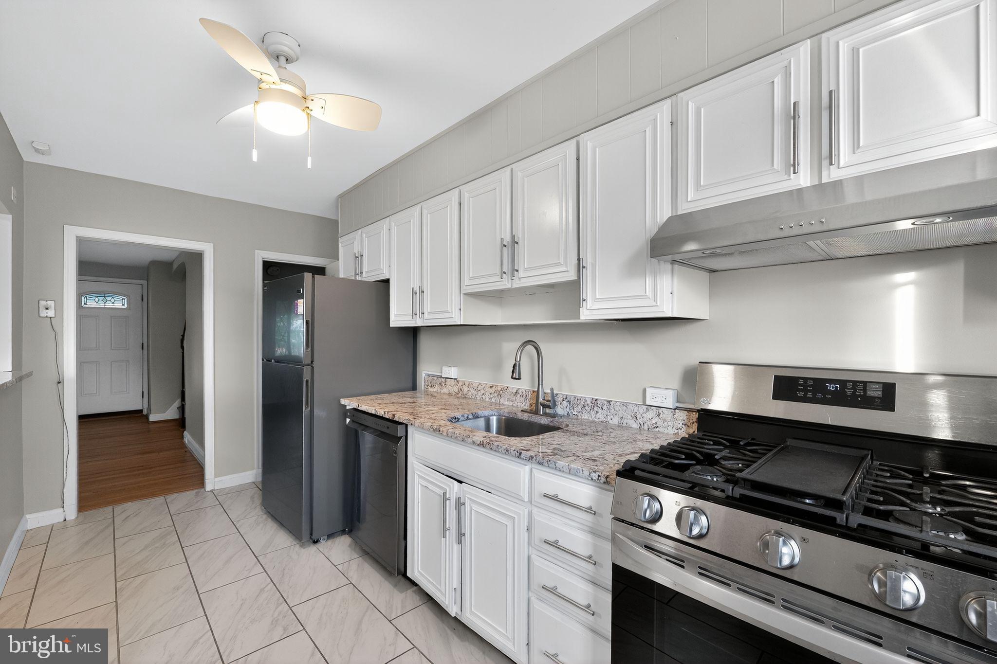 1017 Wicklow Road Baltimore, MD 21229 - Photo 18 of 34 a kitchen with stainless steel appliances granite countertop a stove a refrigerator and a cabinets