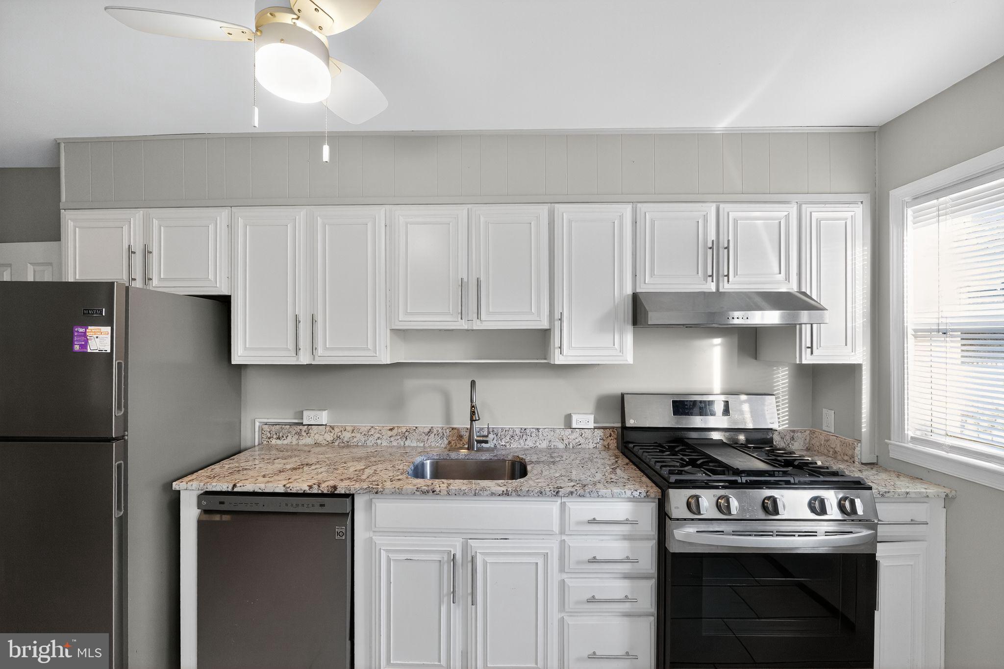 1017 Wicklow Road Baltimore, MD 21229 - Photo 19 of 34 a kitchen with stainless steel appliances granite countertop a sink stove and refrigerator