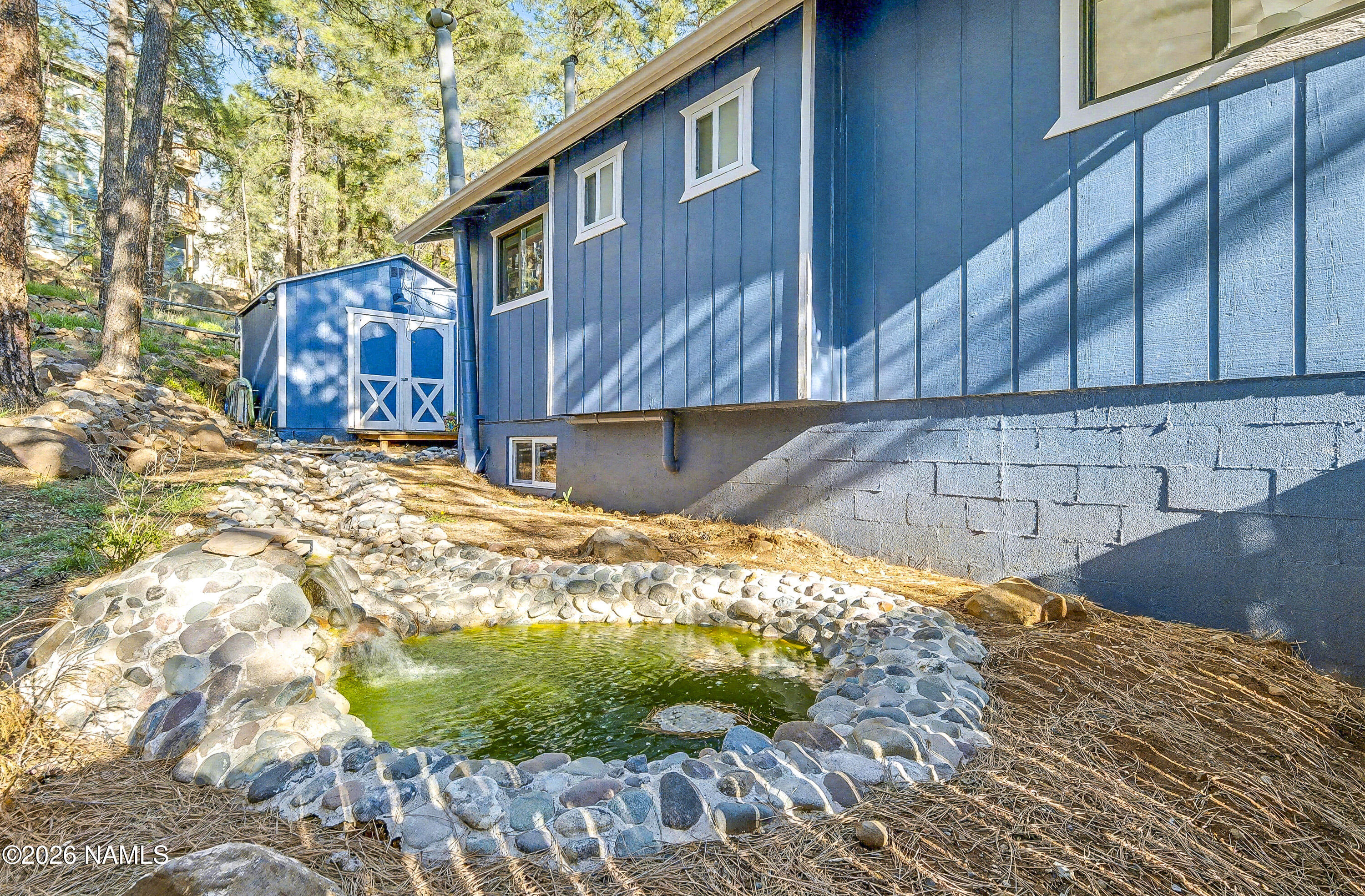 910 North Turquoise Drive Flagstaff, AZ 86001 - Photo 28 of 39 North side of home with water feature