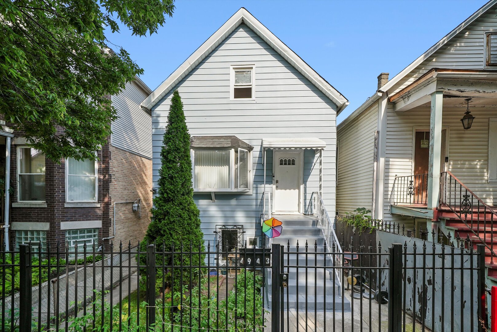 a front view of house along with deck and outdoor seating