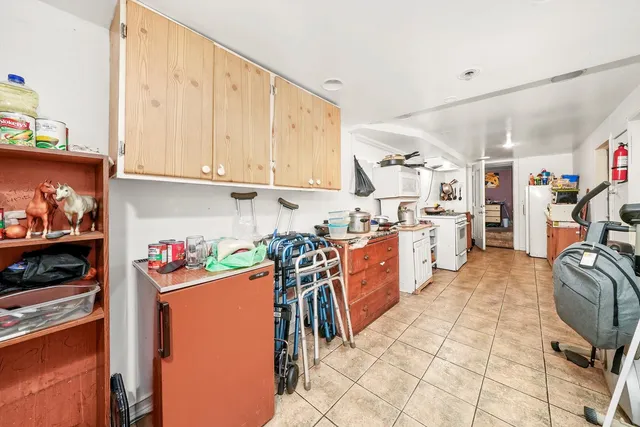 a kitchen with stainless steel appliances kitchen island granite countertop a refrigerator and microwave