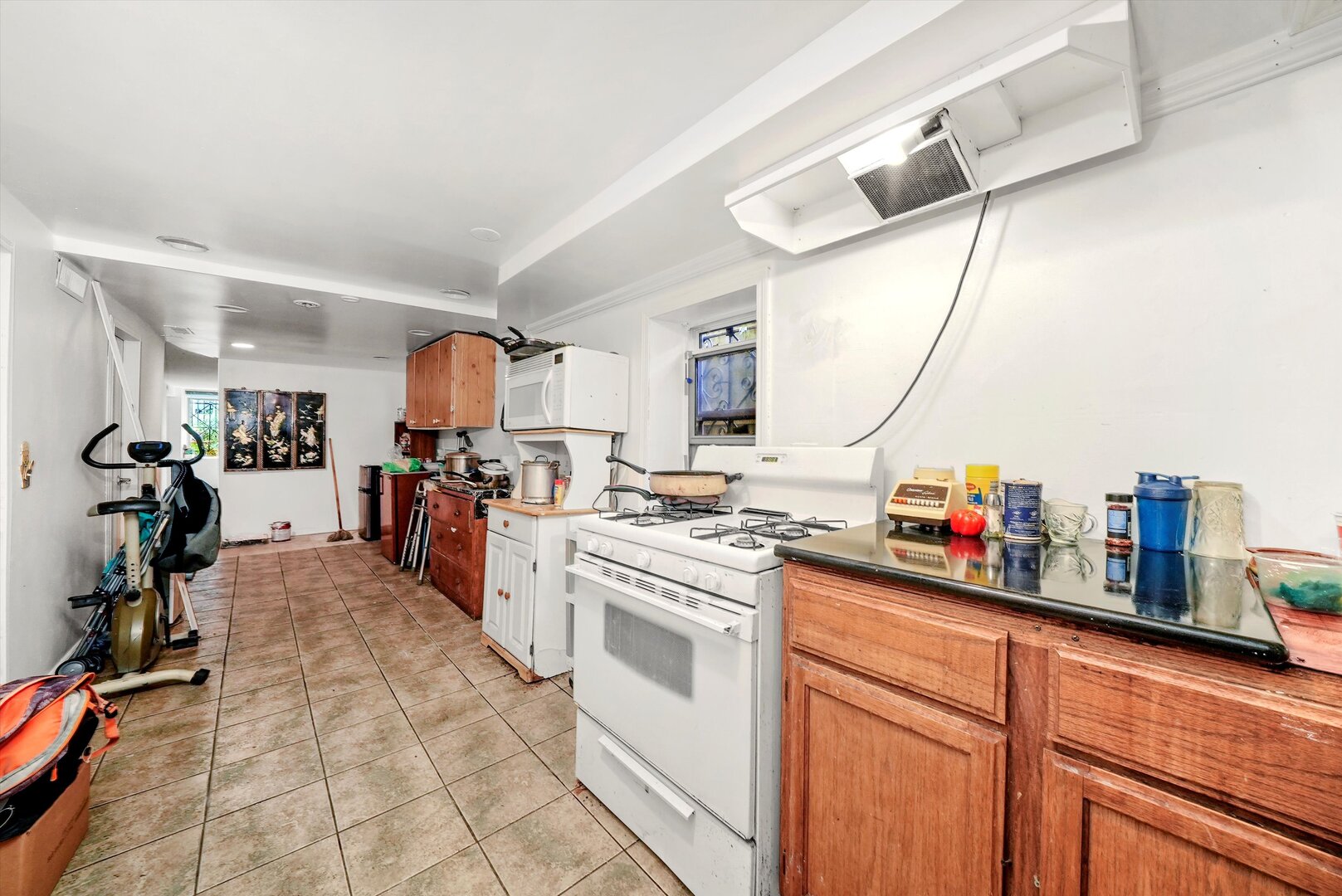 4943 South Marshfield Avenue Chicago, IL 60609 - Photo 14 of 36 a kitchen that has a lot of cabinets in it and appliances