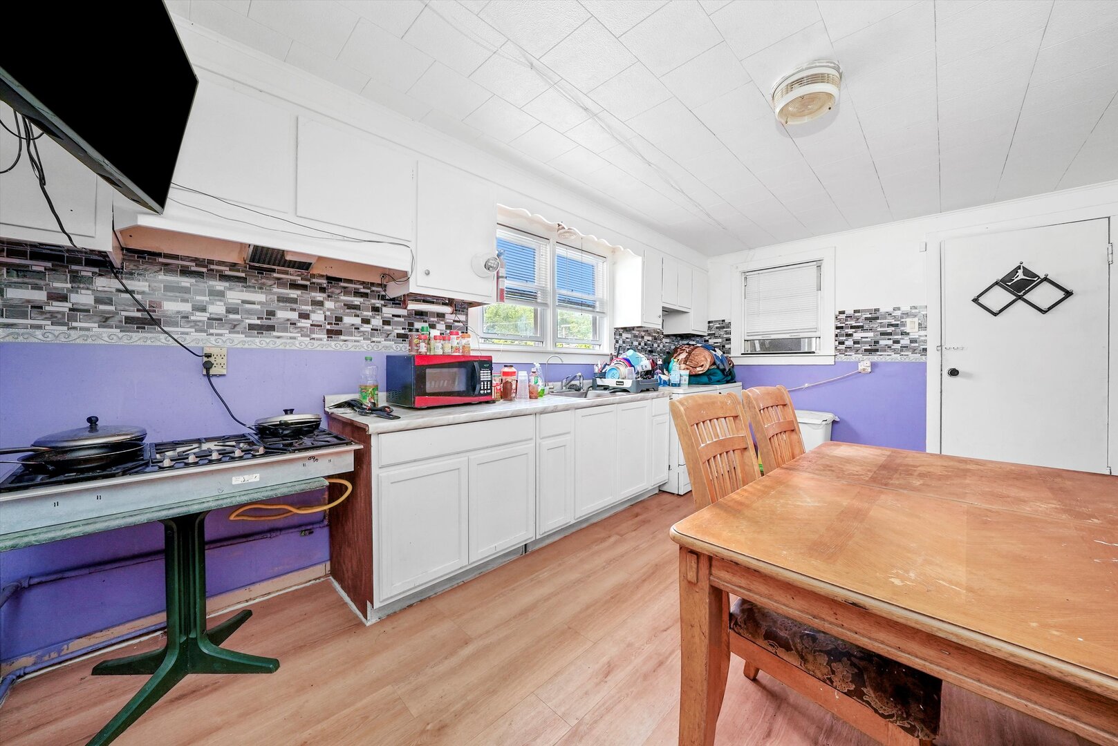 4943 South Marshfield Avenue Chicago, IL 60609 - Photo 16 of 36 a kitchen with a stove a sink dishwasher and a refrigerator with wooden floor