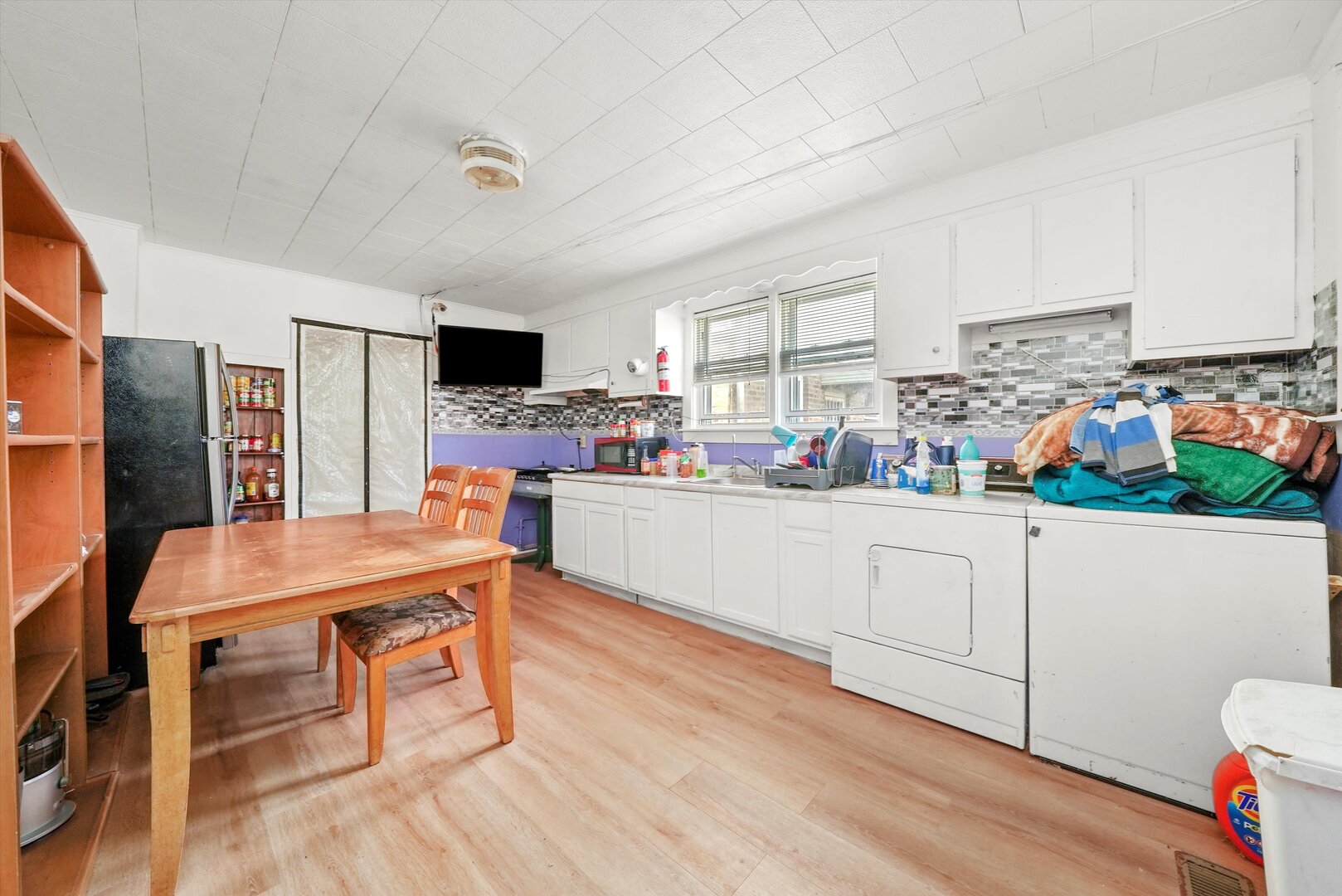 4943 South Marshfield Avenue Chicago, IL 60609 - Photo 19 of 36 a kitchen with stainless steel appliances wooden floor and a refrigerator