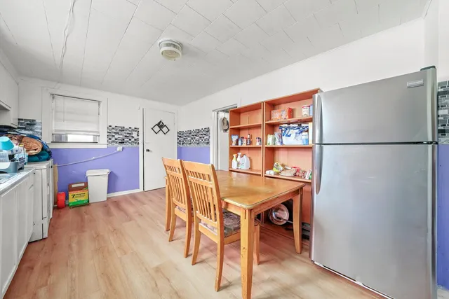 a dining room with furniture and wooden floor