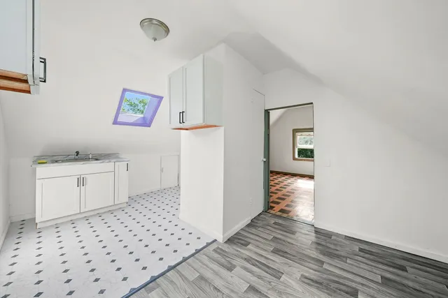 a bathroom with a sink a toilet and a window