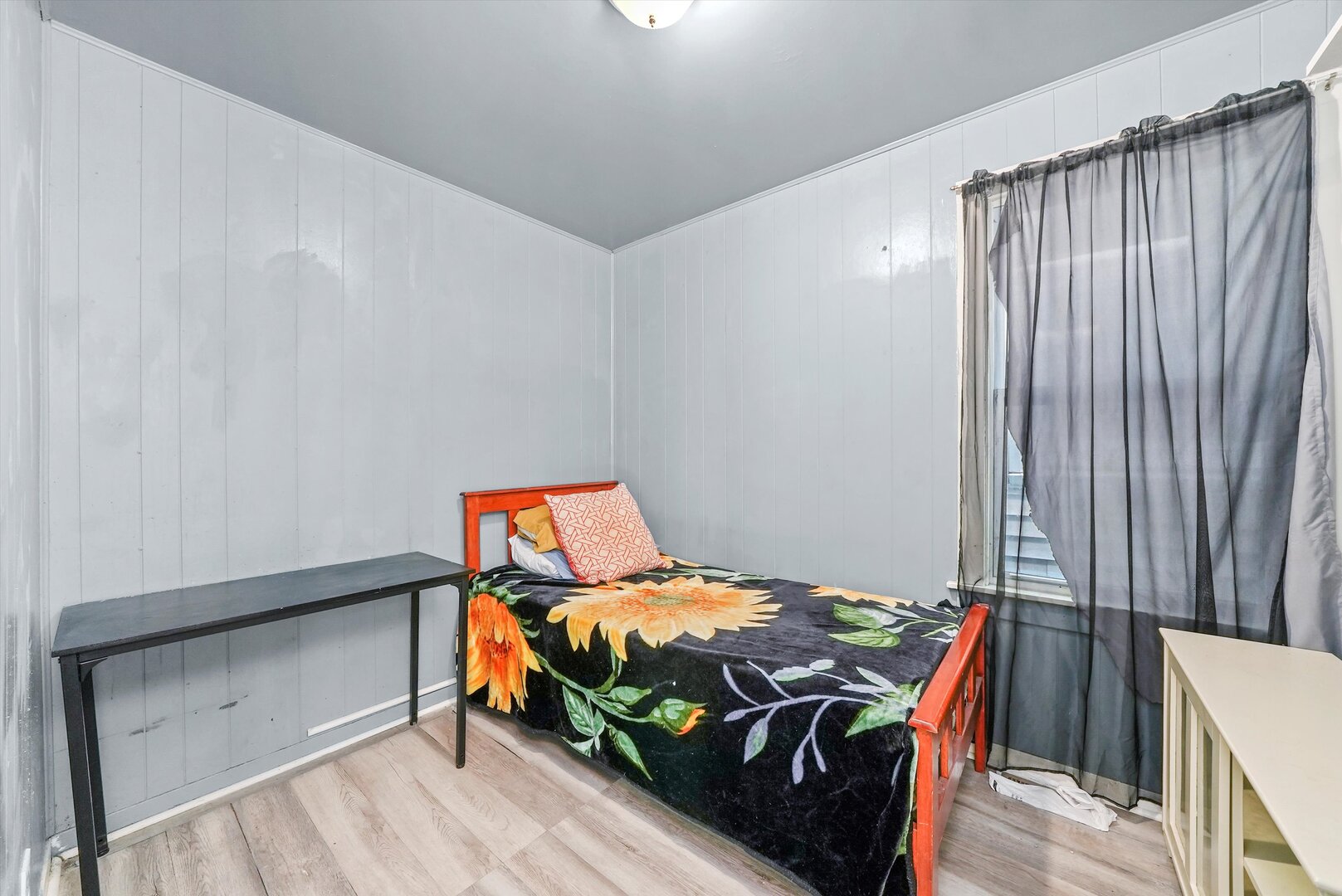 4943 South Marshfield Avenue Chicago, IL 60609 - Photo 31 of 36 a bed sitting in a bedroom next to a window