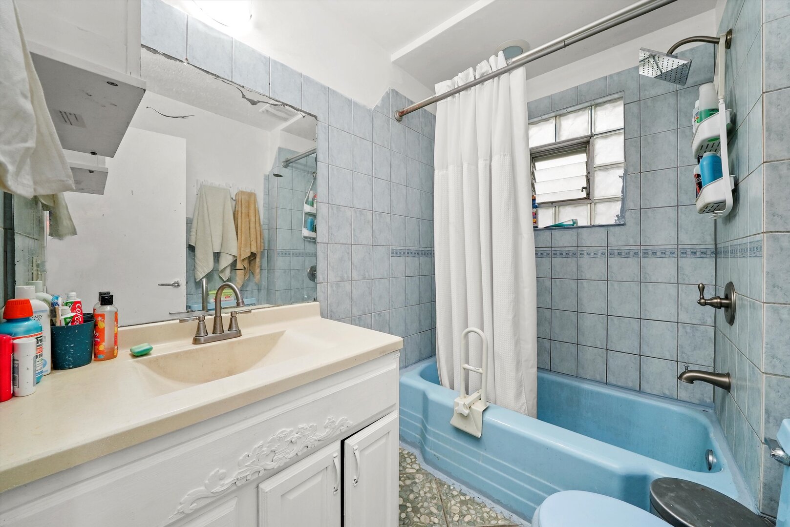 4943 South Marshfield Avenue Chicago, IL 60609 - Photo 32 of 36 a bathroom with a sink mirror toilet and bathtub