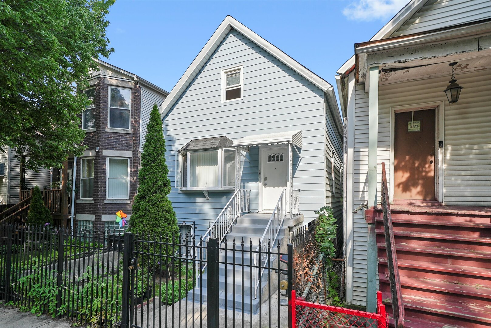 4943 South Marshfield Avenue Chicago, IL 60609 - Photo 5 of 36 a view of a house with a small yard and potted plants