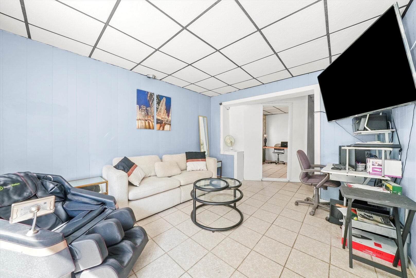 4943 South Marshfield Avenue Chicago, IL 60609 - Photo 7 of 36 a living room with furniture a flat screen tv and a table