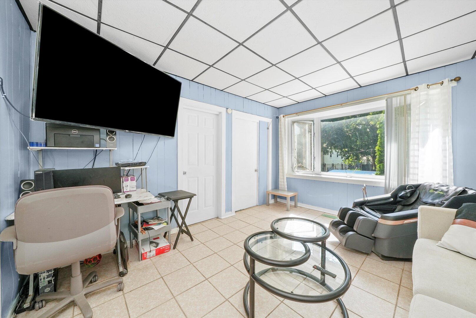 4943 South Marshfield Avenue Chicago, IL 60609 - Photo 9 of 36 a living room with furniture a flat screen tv and a large window