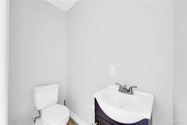 a bathroom with a toilet a sink and mirror