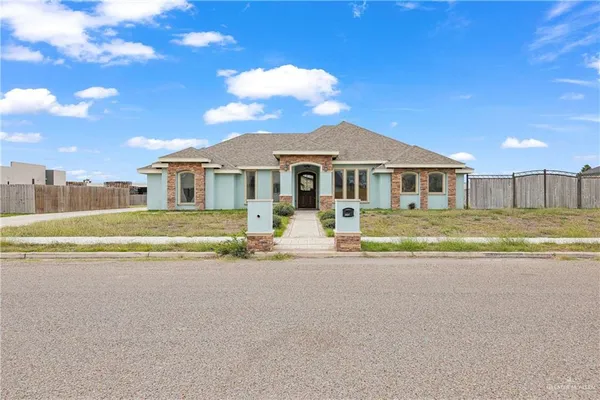 a front view of a house with a big yard