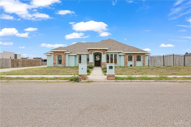a front view of a house with a big yard