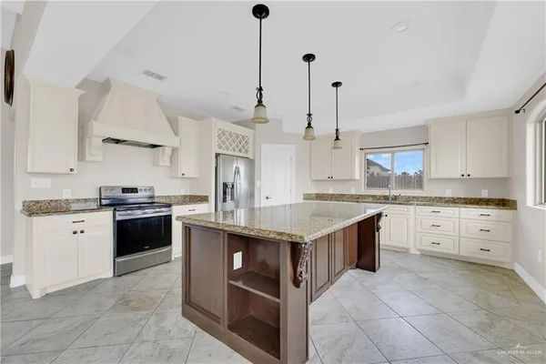 a kitchen with a stove top oven sink and cabinets