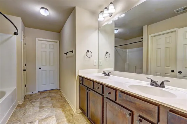 a bathroom with a sink double vanity and a mirror
