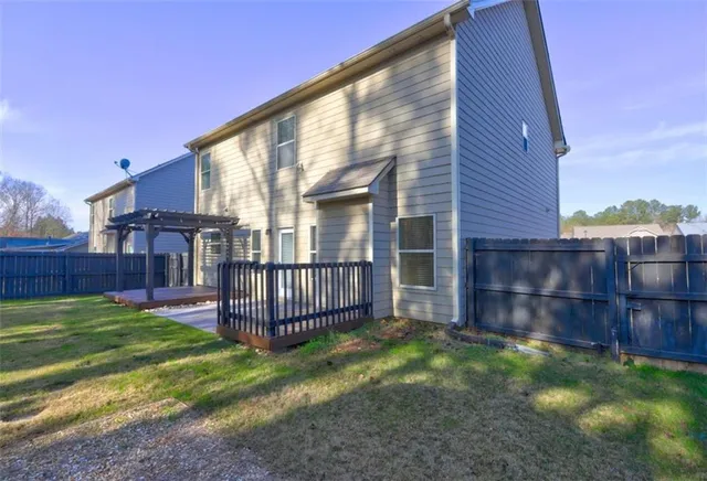 a view of a backyard with wooden fence