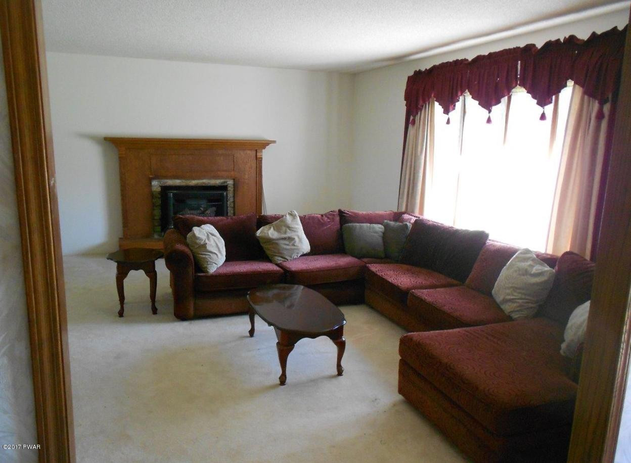 369 Roemerville Road Greentown, PA 18426 - Photo 17 of 45 a living room with furniture and a fireplace