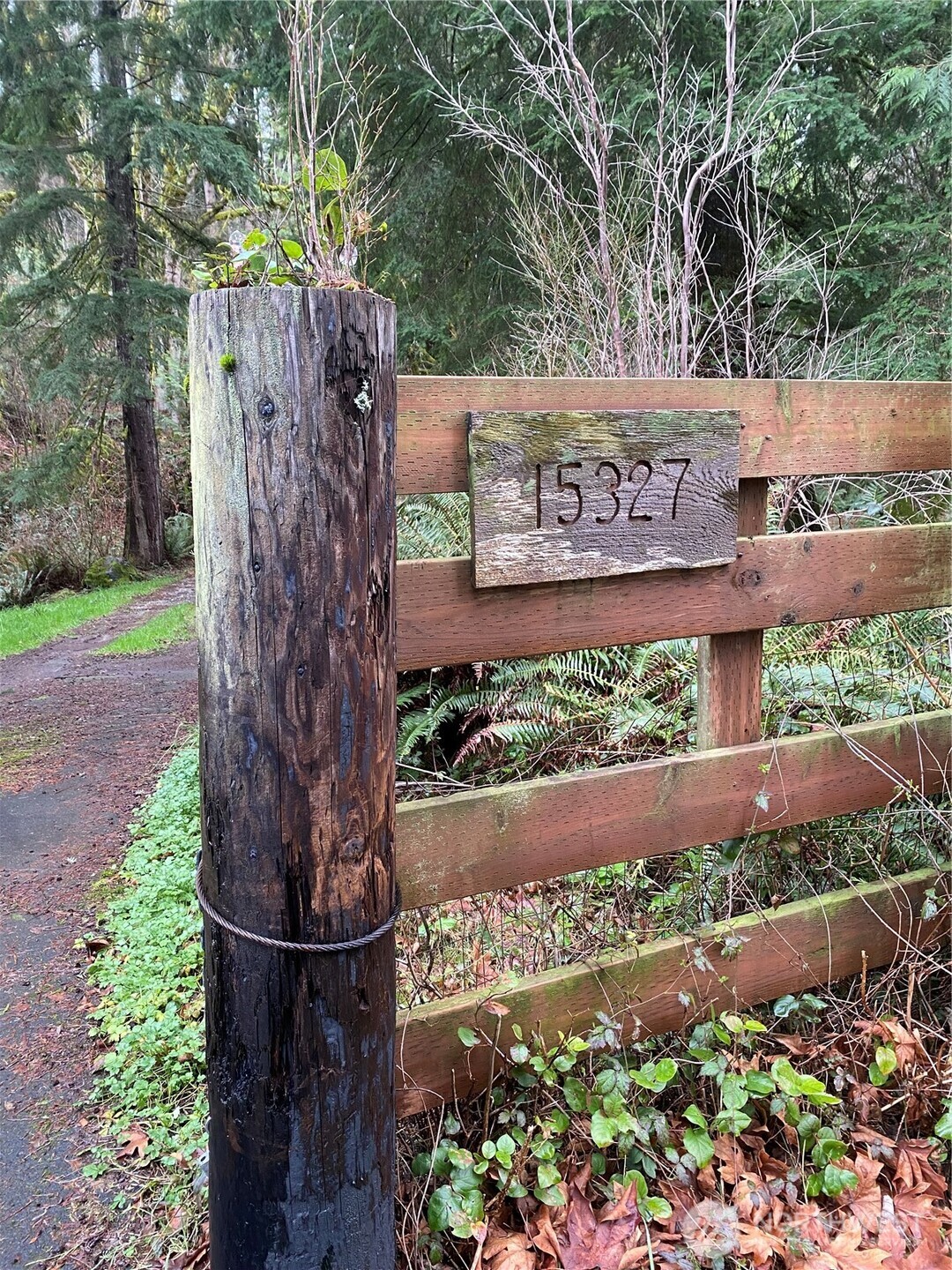 15327 May Creek Road Gold Bar, WA 98251 - Photo 3 of 35 a sign that is sitting in front of flowers