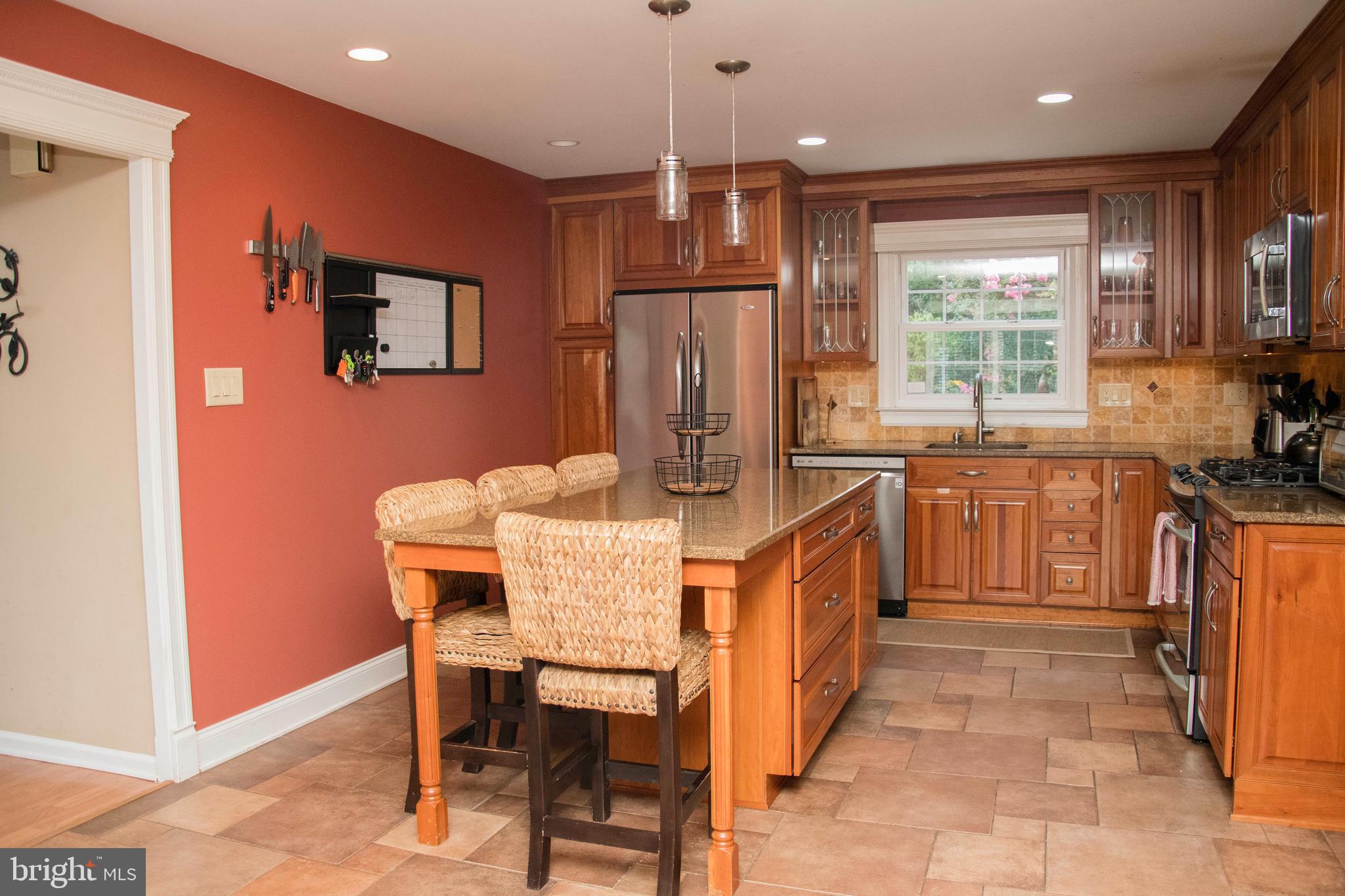 2802 Waterford Drive Cinnaminson, NJ 08077 - Photo 20 of 59 a kitchen with stainless steel appliances kitchen island granite countertop a table chairs in it and a window