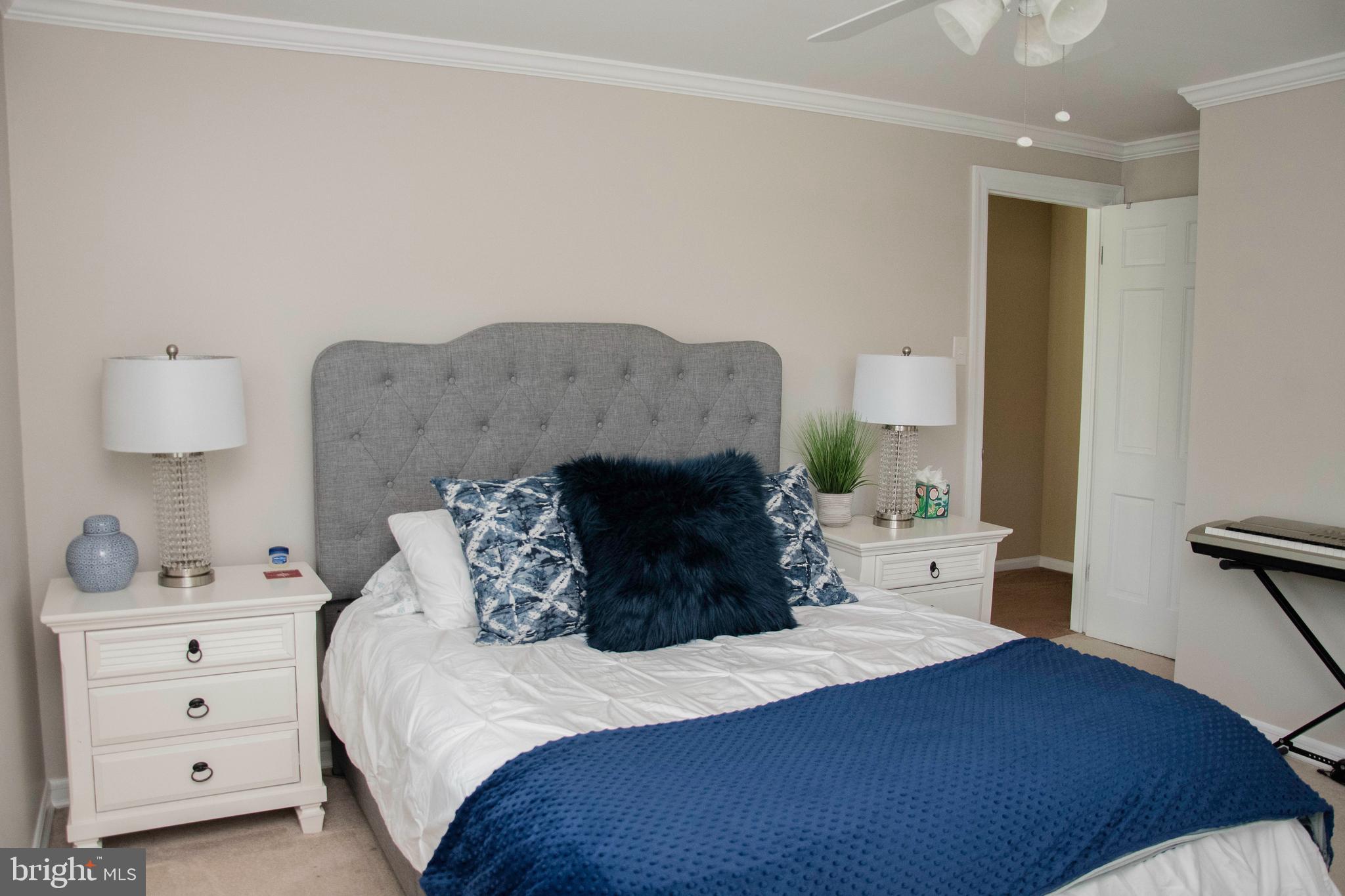 2802 Waterford Drive Cinnaminson, NJ 08077 - Photo 49 of 59 a bedroom with a bed and a lamp on dresser