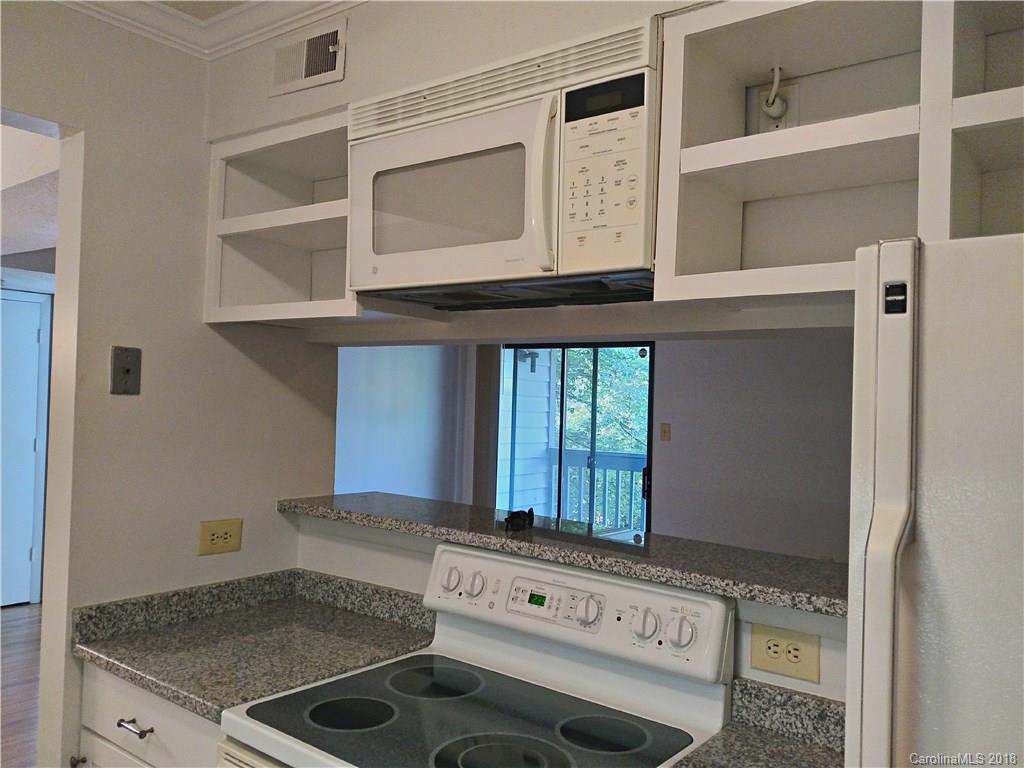 5024 P Sardis Road Charlotte, NC 28270 - Photo 2 of 12 a kitchen with a stove and a microwave