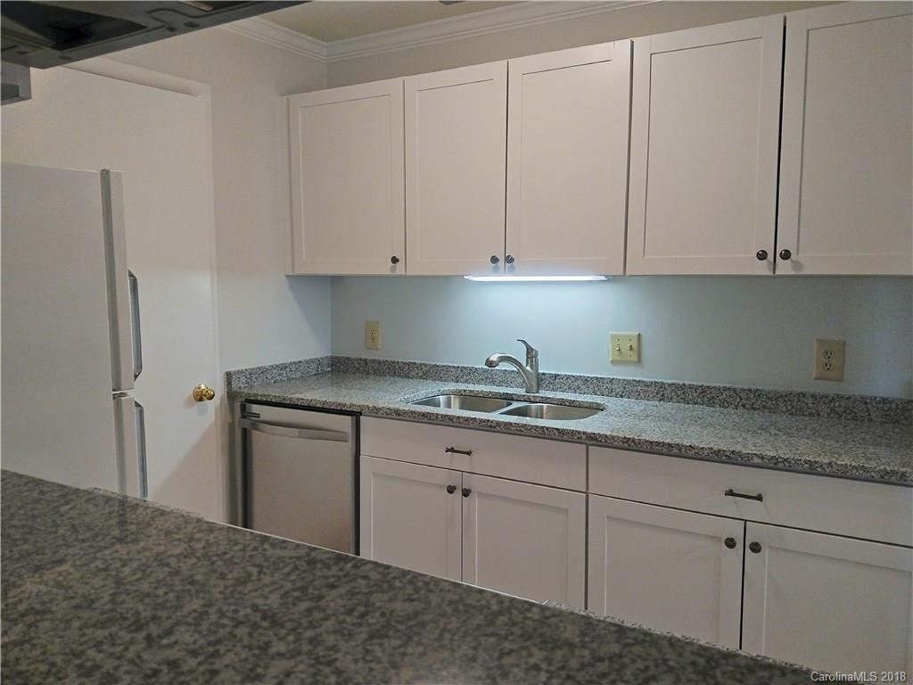 5024 P Sardis Road Charlotte, NC 28270 - Photo 3 of 12 a kitchen with granite countertop white cabinets and stainless steel appliances