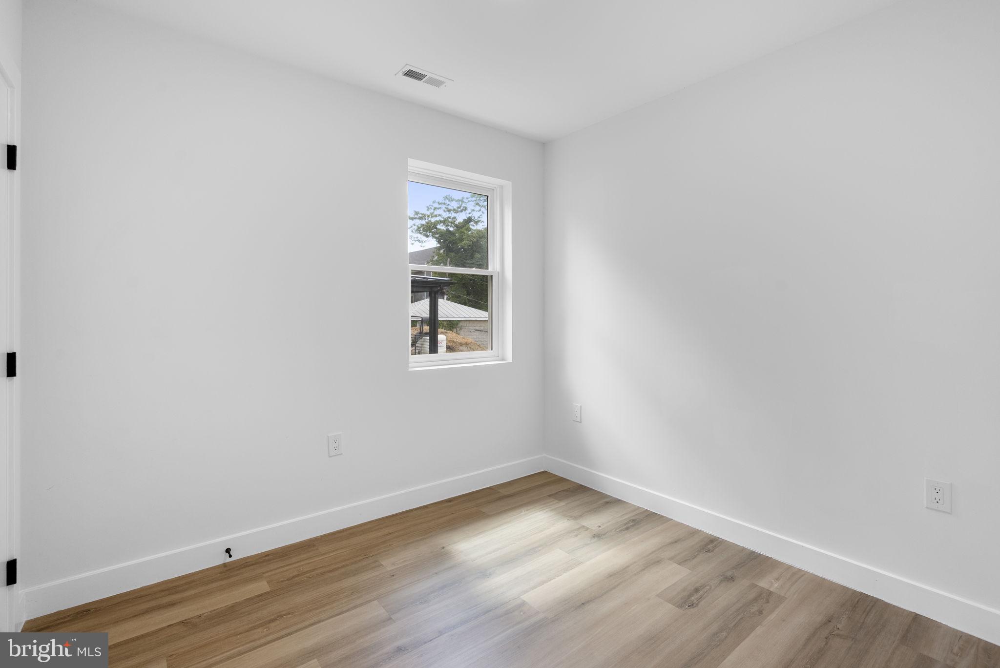2325 High Street Southeast, Unit 3 Washington, DC 20020 - Photo 17 of 28 wooden floor in an empty room with a window