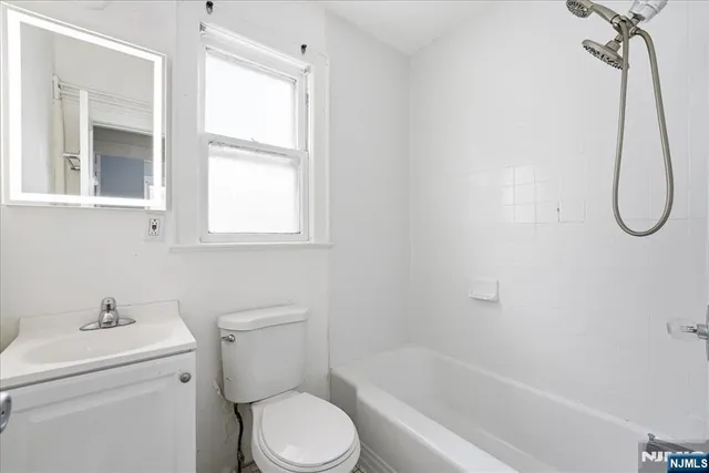 a bathroom with a toilet sink and shower