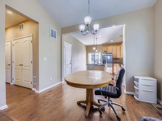 a view of a dining room with furniture wooden floor and chandelier