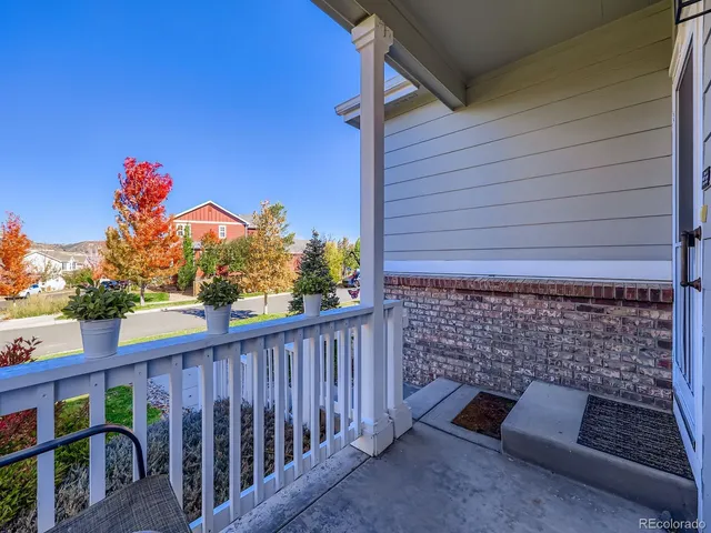 a view of a house with wooden fence and floor to ceiling window