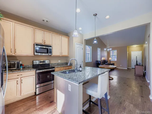 a kitchen with sink a microwave a stove and refrigerator