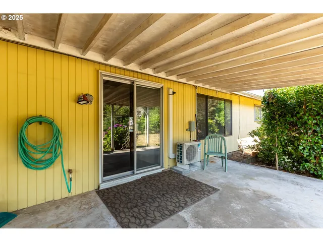 a backyard of a house with yard and outdoor seating