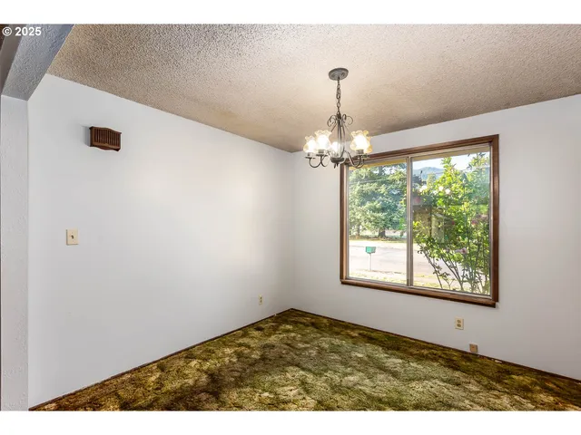 a view of an empty room with windows