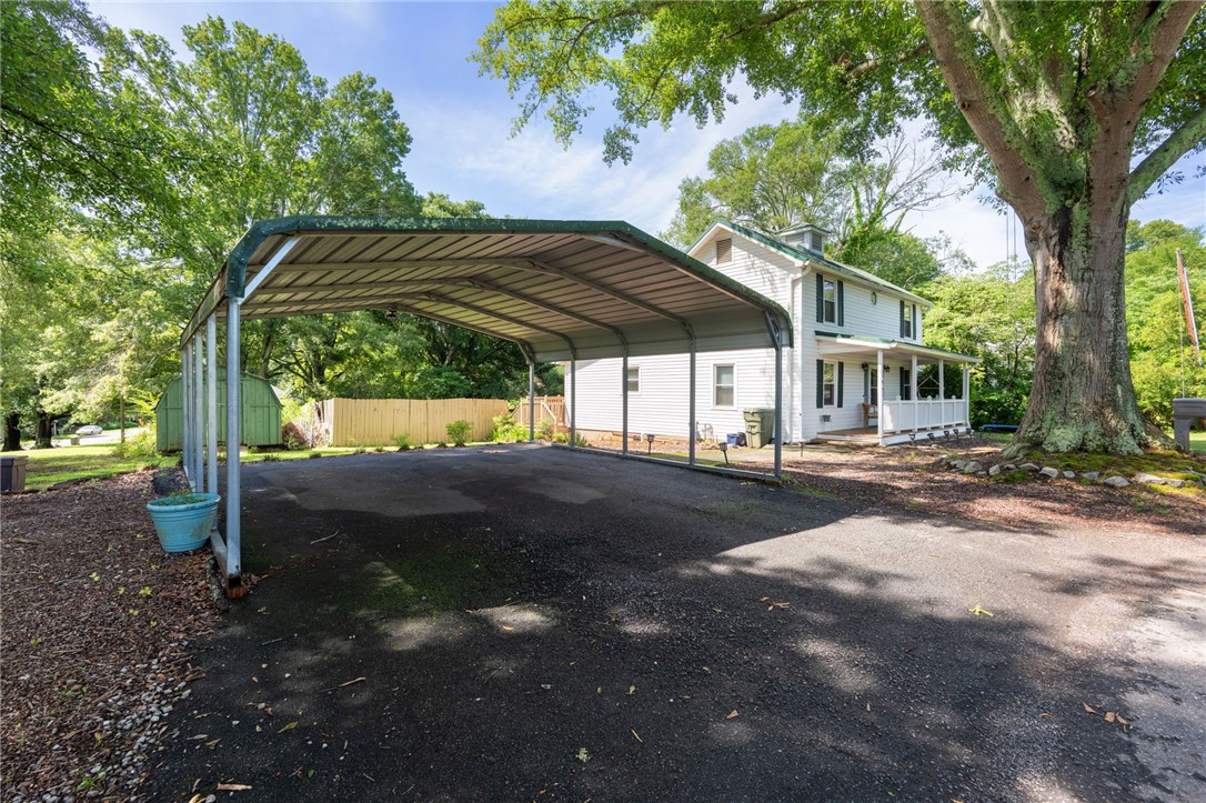108 Tarrant Street Central, SC 29630 - Photo 29 of 42 A classic home with a welcoming front porch and practical carport, nestled among mature trees.