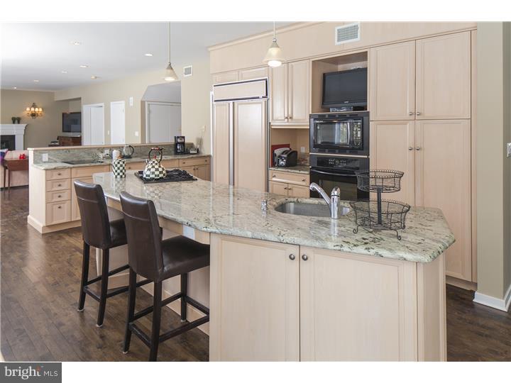 22 Wilson Road Princeton, NJ 08540 - Photo 15 of 25 a kitchen with stainless steel appliances kitchen island granite countertop a table chairs microwave and sink