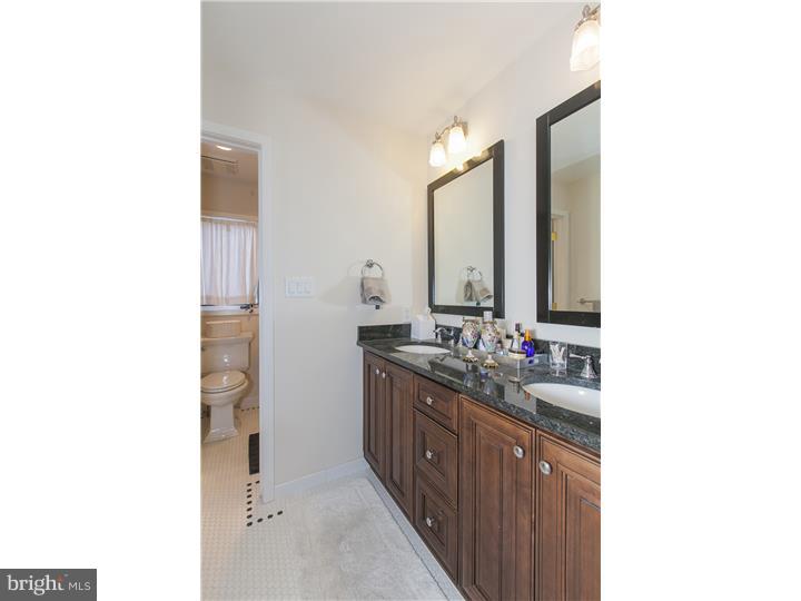 22 Wilson Road Princeton, NJ 08540 - Photo 23 of 25 a bathroom with a double vanity sink a mirror and a