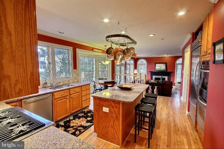 20003 Hickman Way Poolesville, MD 20837 - Photo 11 of 30 a kitchen with stainless steel appliances granite countertop a sink a stove and a refrigerator