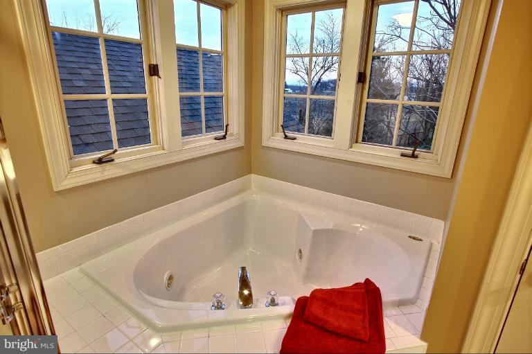 20003 Hickman Way Poolesville, MD 20837 - Photo 15 of 30 a bathroom with a bathtub and a window