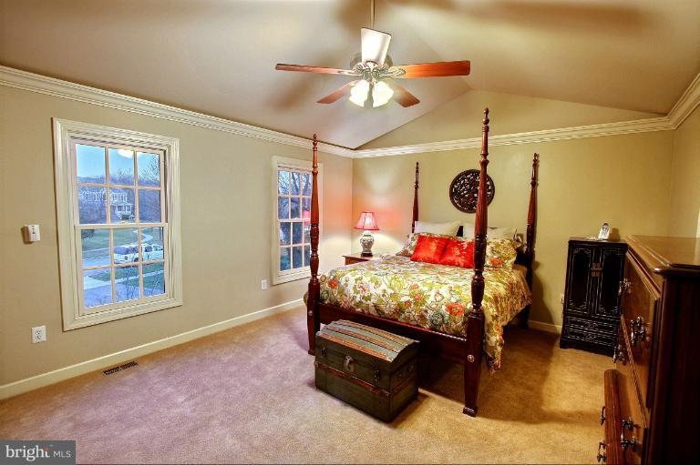 20003 Hickman Way Poolesville, MD 20837 - Photo 16 of 30 a bed room with a bed and a ceiling fan