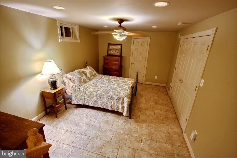 20003 Hickman Way Poolesville, MD 20837 - Photo 20 of 30 a bedroom with a bed and a couch